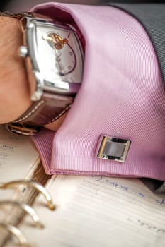 Successful entrepreneur and businessman. Hand of the men conducting the negotiations. Confident man with clock and shirt button on hand. Leader Manager. Expensive watch on a businessman's hand.