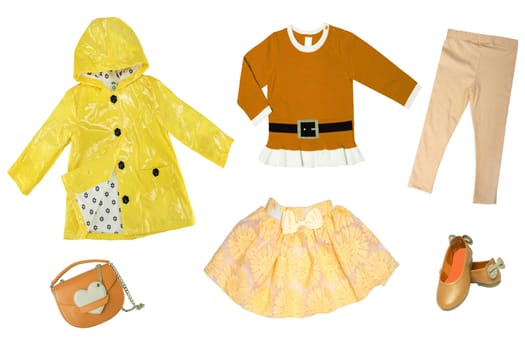 Summer fashion. Collage set of baby child girl clothes isolated on a white background. T-shirts, skirts, shoes or sneaker and rain jacket.