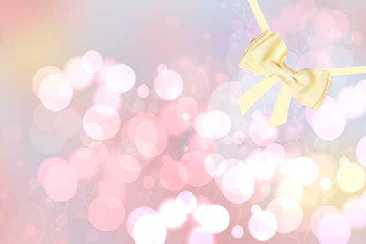 Card concept for Invitation, valentine or holidays. A decorative gold shiny bow made of satin with painted ribbons over bright pastel bokeh with hearts background. Template for your product display montage. Beautiful texture.