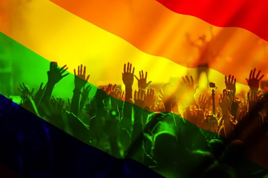 silhouette of a parade of gays and lesbians with a rainbow flag - symbol of love and tolerance