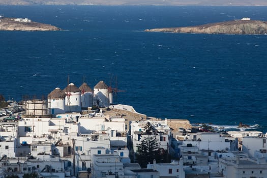 panoramic view of the Mykonos town harbor from the above hills on a sunny summer day, Mykonos, Cyclades, Greece
