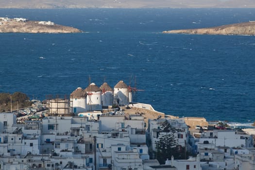 panoramic view of the Mykonos town harbor from the above hills on a sunny summer day, Mykonos, Cyclades, Greece