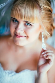 portrait of young beautiful happy bride near the window.