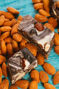 candy paste and almonds on blue wooden background.