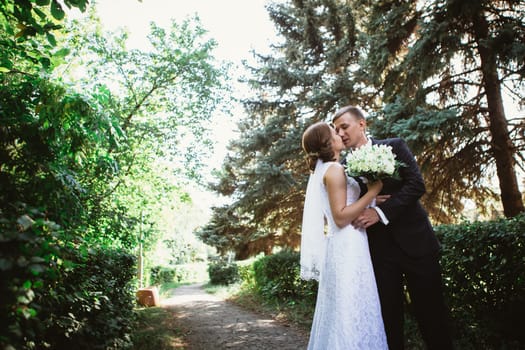 couple bride and groom on a park background.