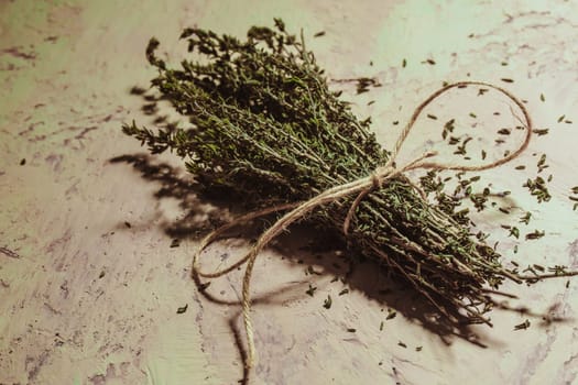 bundle of thyme sprigs on a textural background.