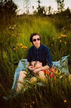 guy and the girl sitting in the grass.