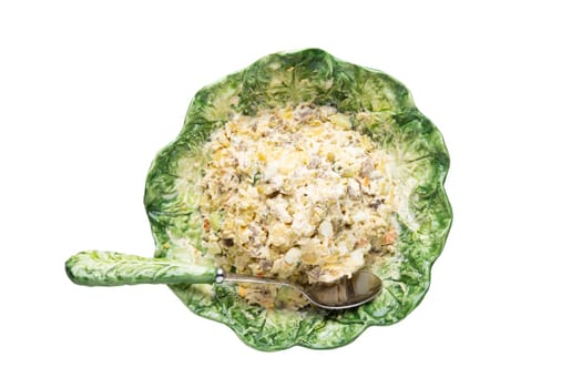 Salad bowl top view. Fresh salad in a decorative green bowl with matching spoon isolated on a white background. Healthy food. Macro.