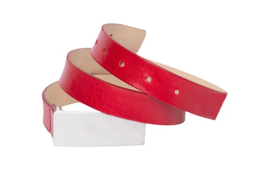 Leather belt isolated. Stylish female elegant red rolled leather belt isolated on a white background. Fashionable womans accessories. Macro.