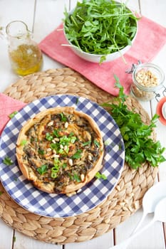 Little quiche with fresh parsley and pine seeds