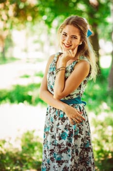 Young beautiful girl in floral dress.