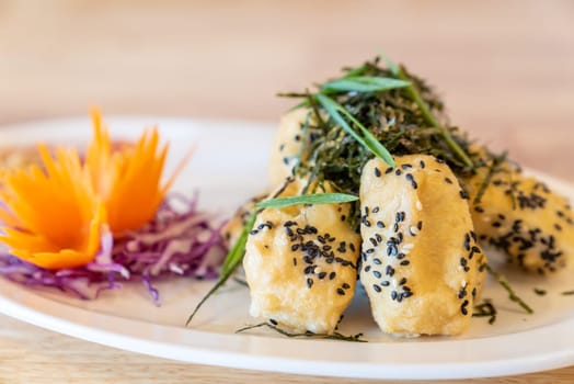 deep fried organic tofu topping with organic black sesame seaweed and leek. Thai Chinese organic street food and cuisine.