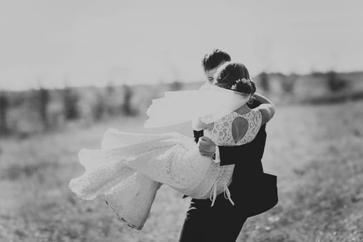 black white photography a pair of bride and groom on the background of the park's trees