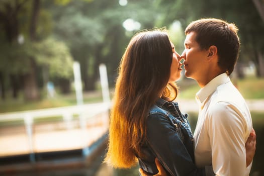 Beautiful young couple on the lake background.