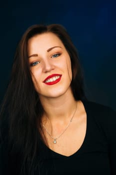 emotional girl smiling on a dark background.