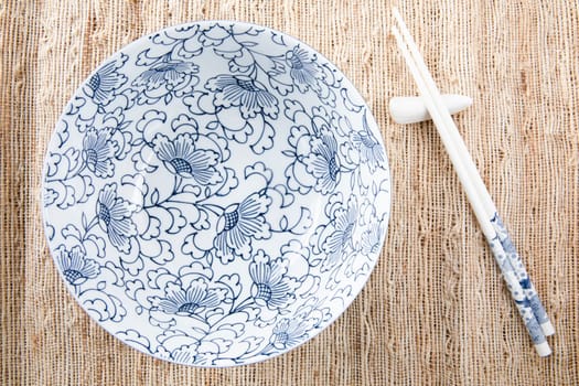 Filling bowl with udon noodle soup series image one, bowl and chopsticks.