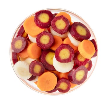 Red, yellow, and orange carrot slices in bowl and isolated on a white background