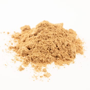 Heap of ground coriander isolated on a white background.
