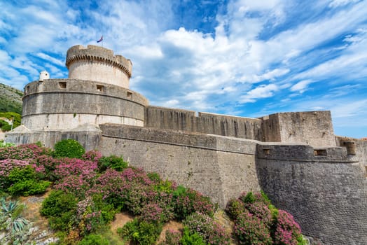 View of the city walls of Dubrovnik, Croatia with colorful flowers