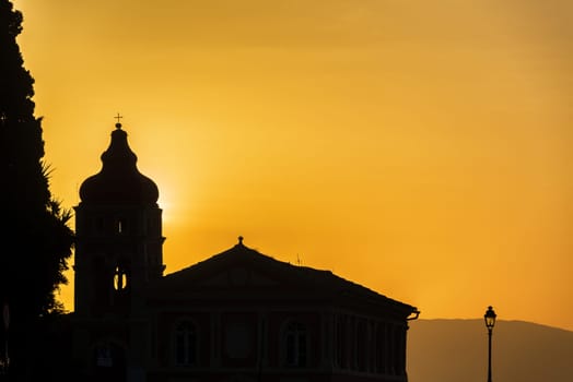 Silhouette of a church at sunrise in Corfu, Greece