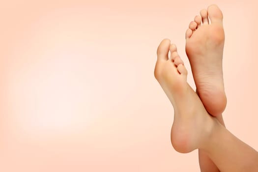 Female feet against pastel background