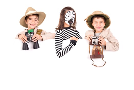 Children's group in safari clothes and face-paint over a white board