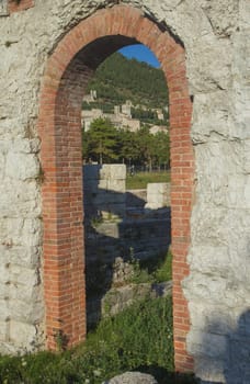 A view of the city of Gubbio through the ruins of ancient amphitheater (Gubbio, Umbria, Italy)