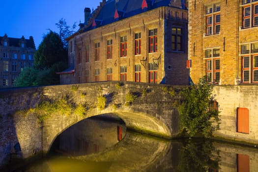 Ancient stone bridge at Dijver Canal in Bruges at night. (Belgium)
