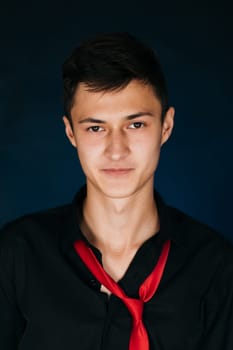 Portrait young guy on a dark studio.
