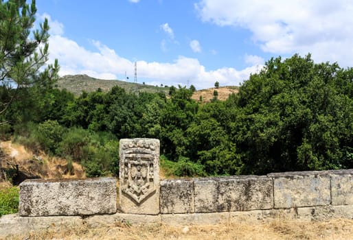 Detail of the royal shield of King Pedro, the Second, at the southern end of the bridge of Lavandeira, near Celorico da Beira, Beira Alta, Portugal