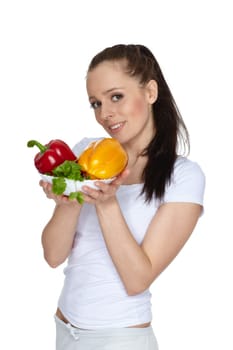 Young beautiful woman with fresh vegetables on a white background. Concept of healthy food.