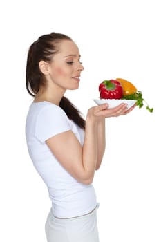 Young beautiful woman with fresh vegetables on a white background. Concept of healthy food.