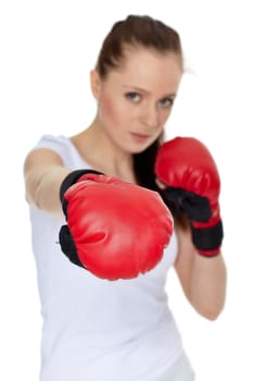 Sporty young woman in red fighting gloves on a white background.