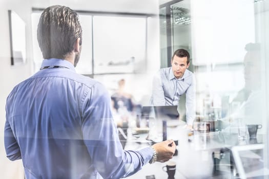 Business team brainstorming on meeting in modern corporate office. Business executive delivering presentation to colleagues during meeting or in-house business training. Business and entrepreneurship.