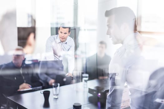 Business team brainstorming on meeting in modern corporate office. Business executive delivering presentation to colleagues during meeting or in-house business training. Business and entrepreneurship.