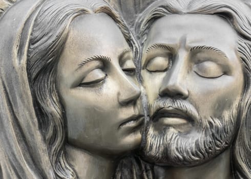 Bas-relief in bronze representing The Pity of Michelangelo. Faces of Holy Mary mother and Jesus Christ after the Crucifixion.