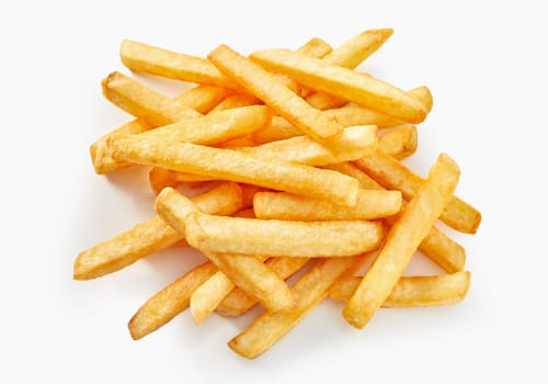 Long cut of french fries in flat lay view on white background.