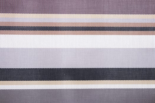 Striped background. Top view of details of colorful horizontal striped background texture with seamless pattern on plastic tissue. Macro.