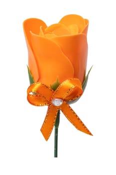 Summer flower background. Closeup of a artificial orange flower with a matching ribbon bow isolated on a white background. Design element for valentine, wedding or other holidays. Macro.