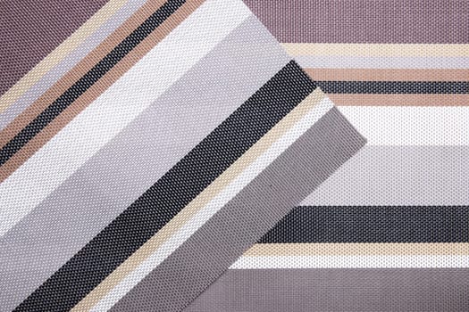 Striped background. Top view of details of colorful striped background texture with seamless pattern on plastic tissue. Macro.