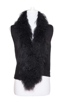 Vest isolated. Black women vest with a large fur collar on mannequin isolated on a white background. Woman fashion.