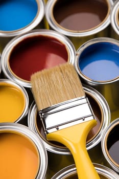 Can with paint and paintbrush, yellow background