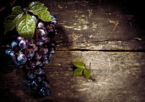 Top view of the bunch of red grapes on old wooden table with copy space