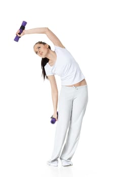 Young sports woman with dumbbells on a white background. Training.