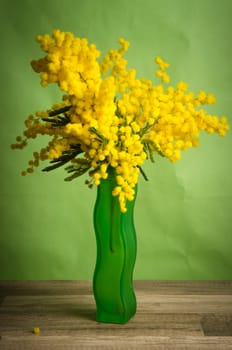 Spring bouquet with mimosa and tulips in a vase