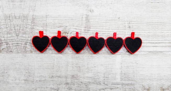 Valentines day with red hearts on wooden background