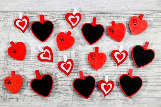 Valentines day with red hearts on wooden background