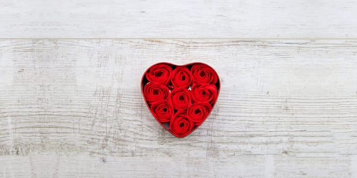 Red roses in a heart-shaped box