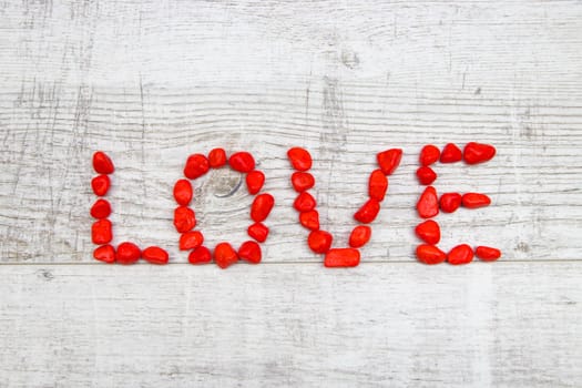 Red Pebble Stones on Wooden Background - Valentine's Day