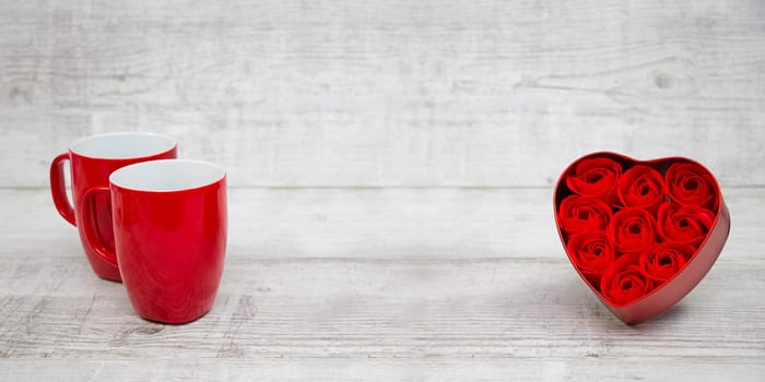 Shiny Red coffee cups and red heart roses